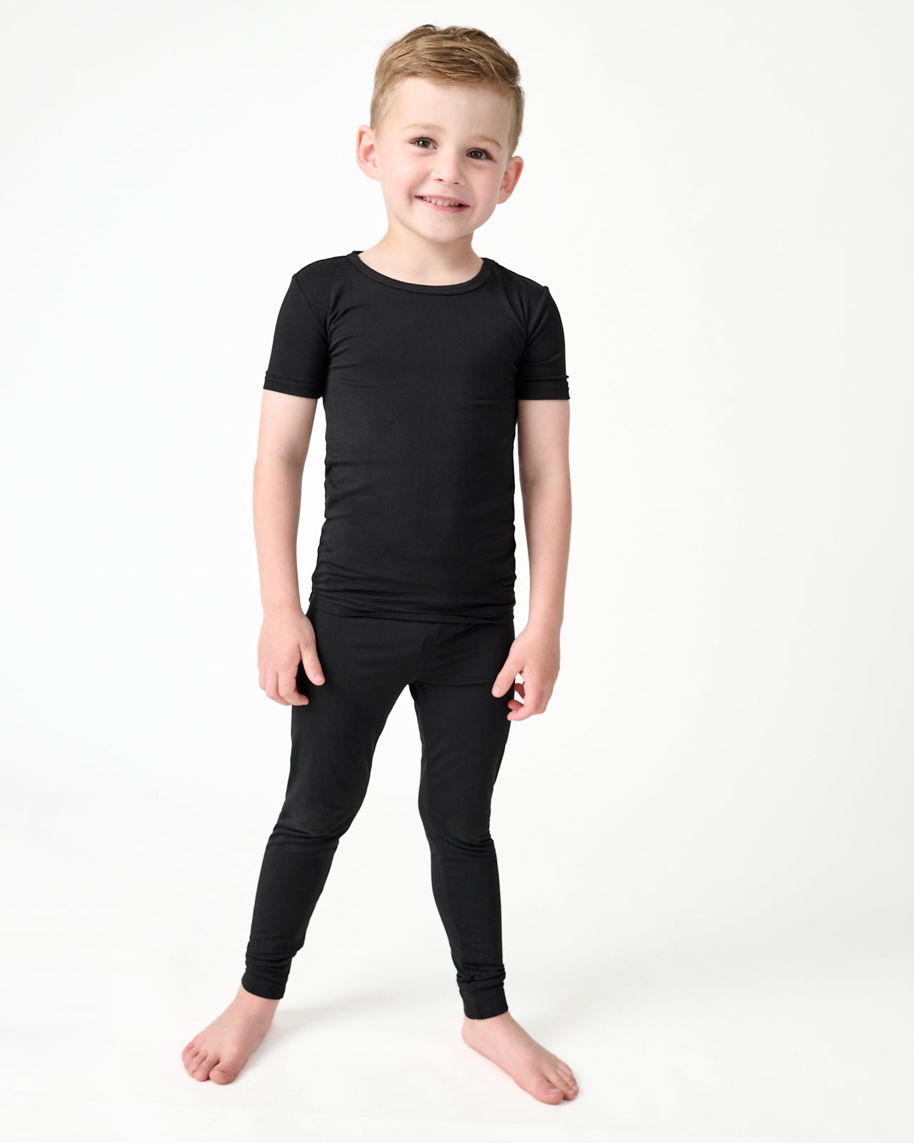 Boy wearing the Black Two-Piece Short Sleeve and Pants Pajama Set