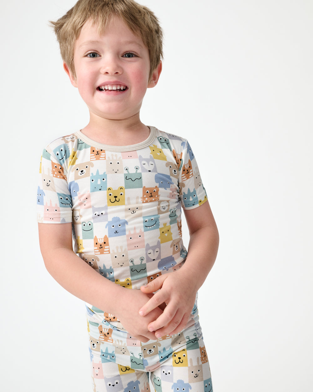 Boy wearing the Check Mates Two-Piece Short Sleeve Pajama Set
