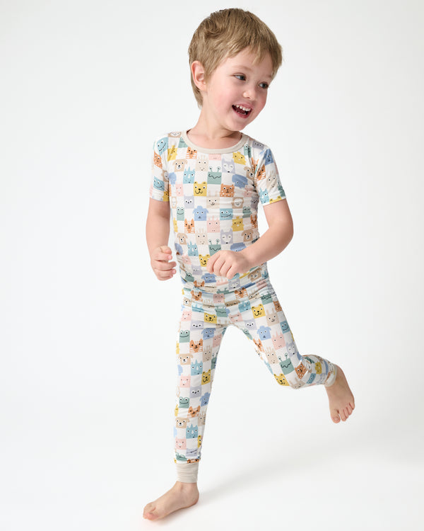 Child in motion wearing the Check Mates Two-Piece Short Sleeve Pajama Set