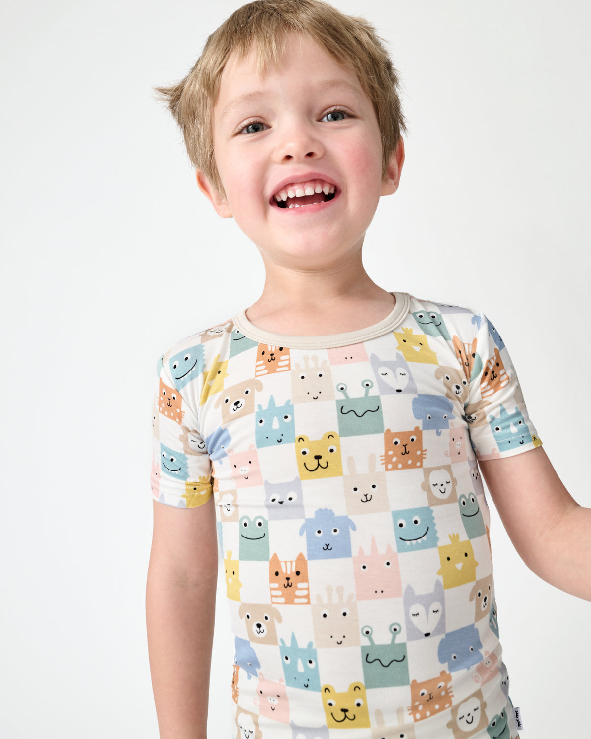 Close up of child wearing the Check Mates Two-Piece Short Sleeve Pajama Set