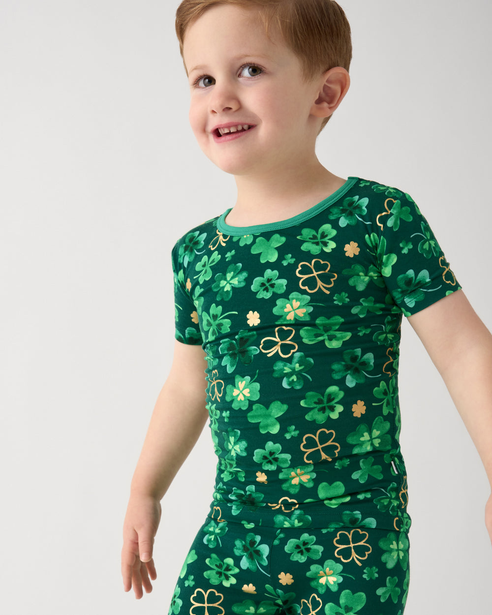 Close up of boy wearing the Clover Cuties Two-Piece Short Sleeve Pajama Set