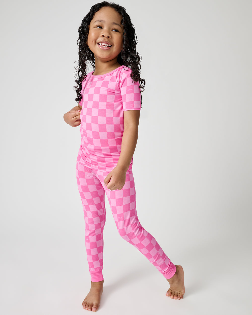 Standing girl wearing the Sweet Raspberry Checks Two-Piece Short Sleeve Pajama Set