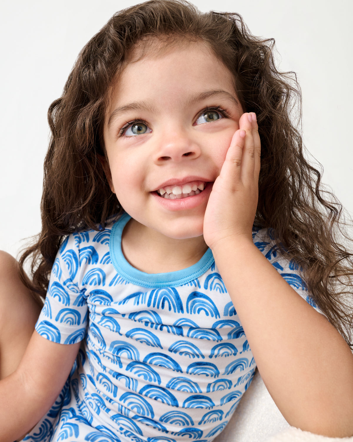 Close up of child wearing the Blue Rainbows Two-Piece Short Sleeve & Shorts Pajama Set