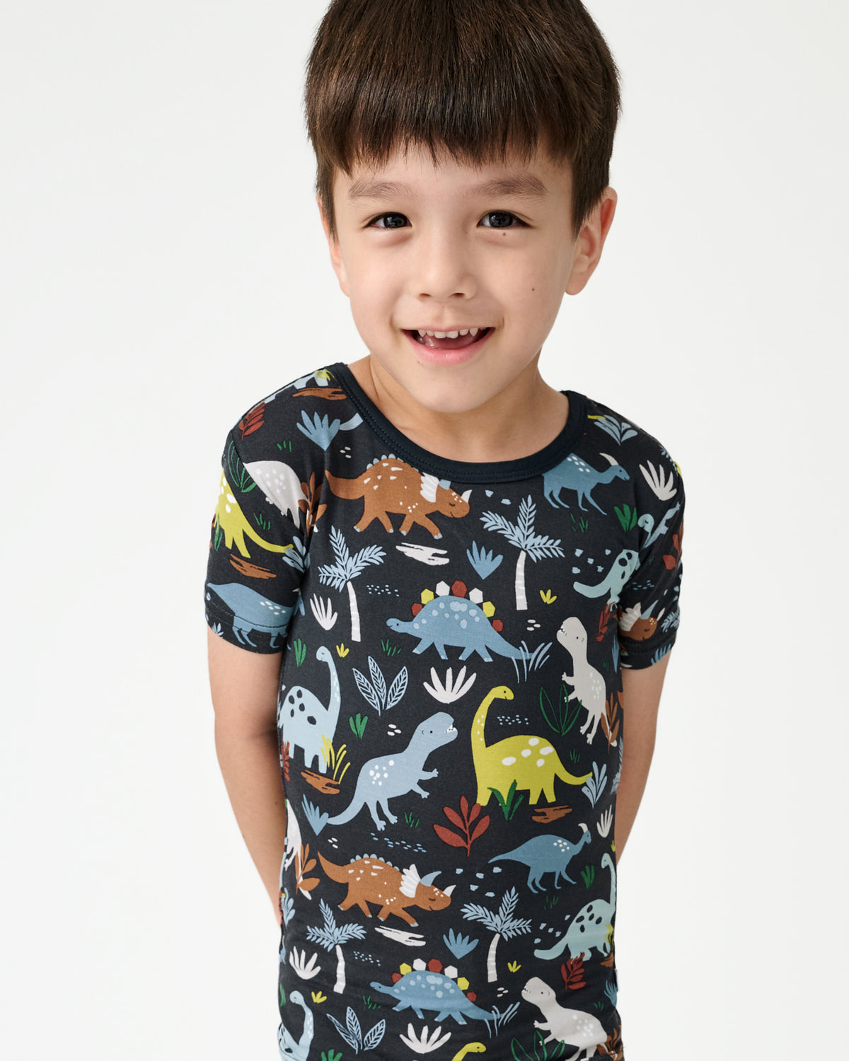 Close up of boy wearing the Navy Jurassic Jungle Dinosaur Print Pajamas