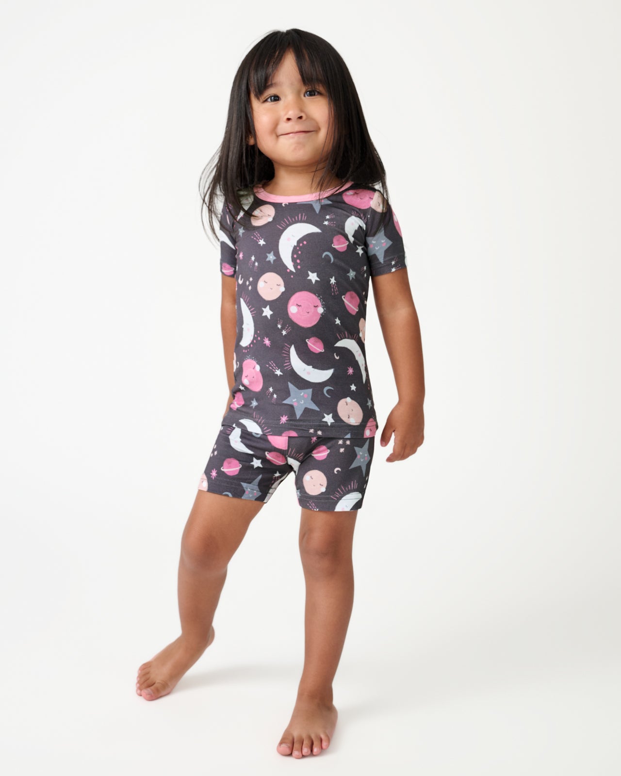 Girl wearing the Pink To the Moon & Back Two-Piece Short Sleeve & Shorts Pajama Set