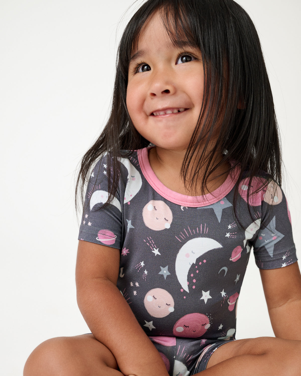 Close up of girl wearing the Pink To the Moon & Back Two-Piece Short Sleeve & Shorts Pajama Set