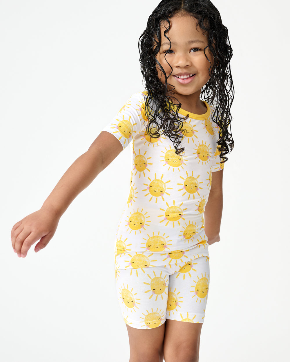 Girl wearing the Sunshine Two-Piece Short Sleeve & Shorts Pajama Set