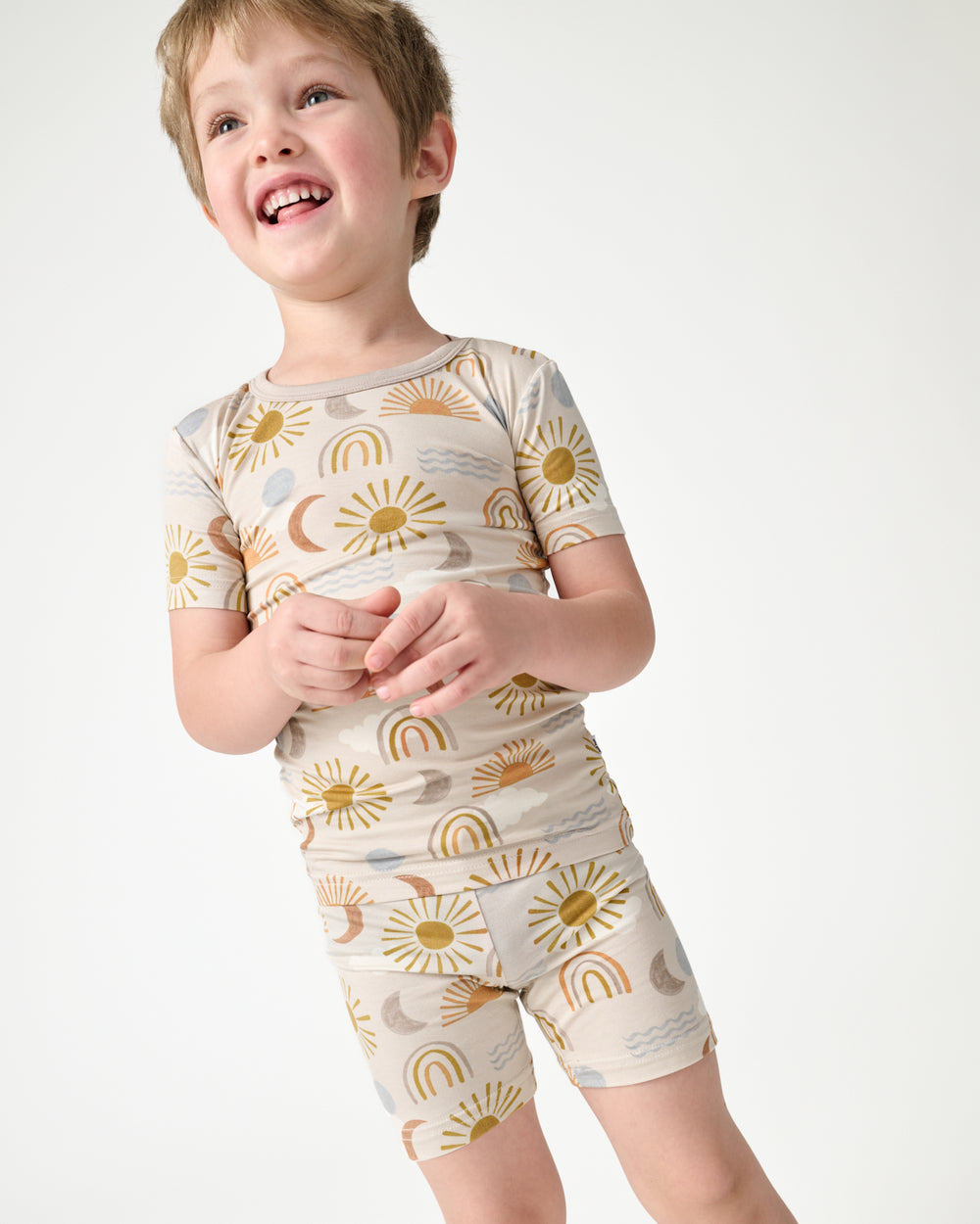 Close up of boy wearing the Desert Sunrise Two-Piece Short Sleeve & Shorts Pajama Set