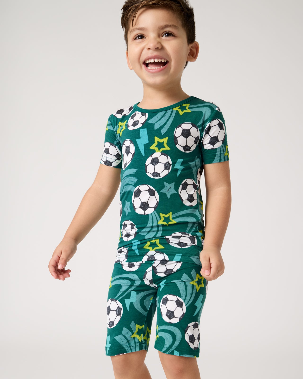 Close up of boy wearing the Soccer Stars Two-Piece Short Sleeve & Shorts Pajama Set