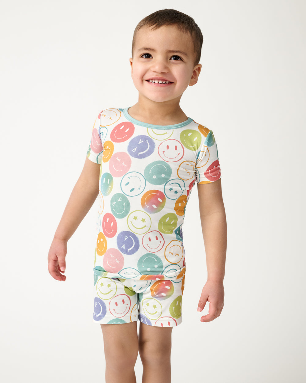 Close up of boy wearing the Positive Vibes Two-Piece Short Sleeve & Shorts Pajama Set