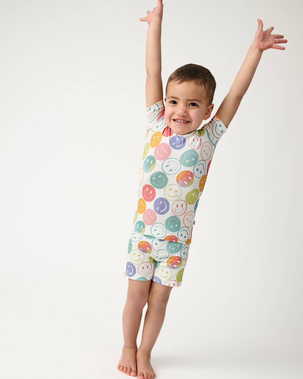 Posing boy wearing the Positive Vibes Two-Piece Short Sleeve & Shorts Pajama Set