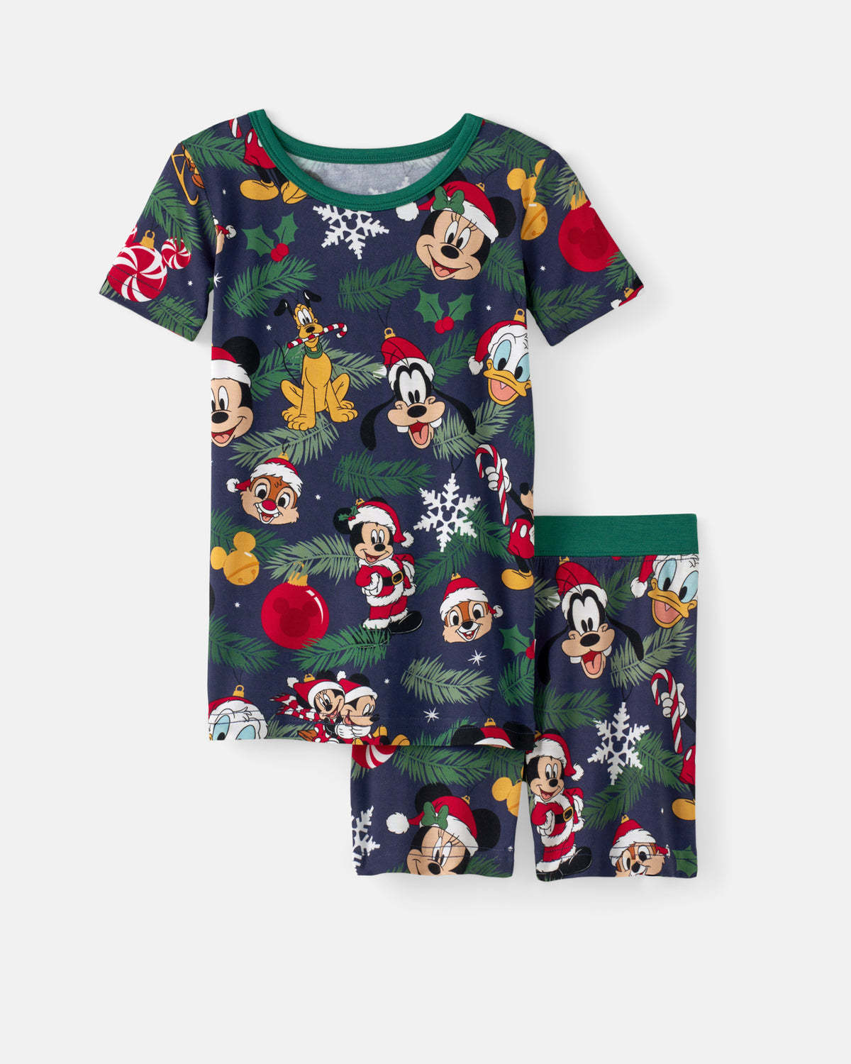 A two-piece children's pajama set featuring a dark navy blue Christmas-themed print with Mickey Mouse, Minnie Mouse, Donald Duck, and Goofy faces, decorated with Santa hats, snowflakes, pine branches, and red ornaments, shown on a light gray background.