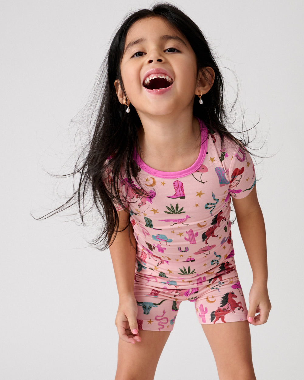 Close up of girl wearing the Pink Rancher Roundup Two-Piece Short Sleeve & Shorts Pajama Set