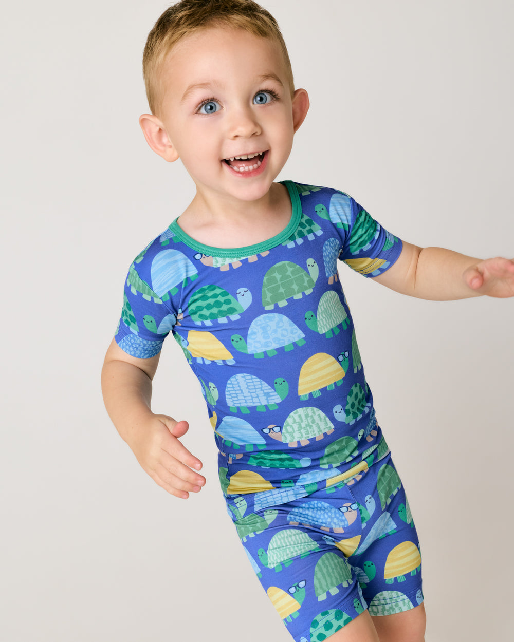 Close up of boy wearing the Shell Parade Two-Piece Short Sleeve & Shorts Pajama Set