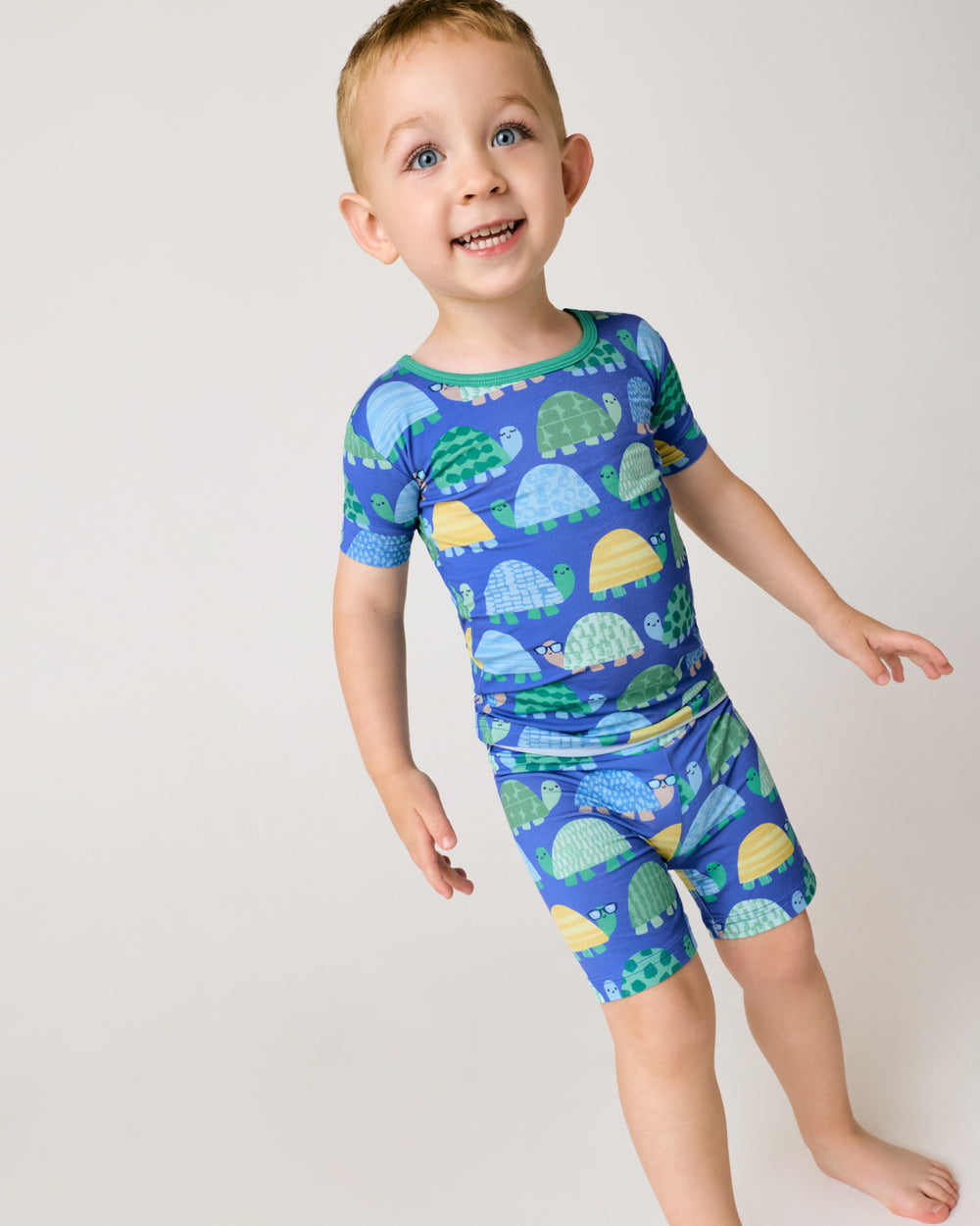 Standing child wearing the Shell Parade Two-Piece Short Sleeve & Shorts Pajama Set