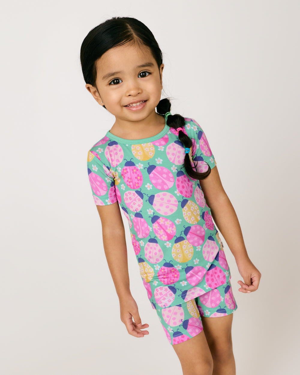 Close up of girl wearing the Ladybug Meadow Two-Piece Short Sleeve & Shorts Pajama Set