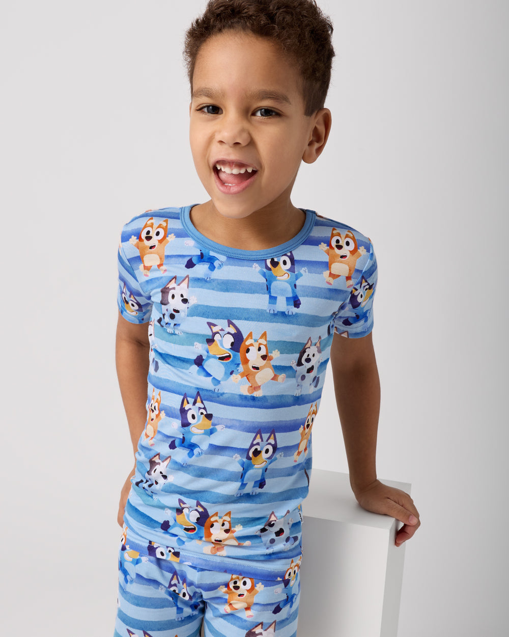 Close up of boy wearing the Bluey Dance All Day Two-Piece Short Sleeve & Shorts Pajama Set