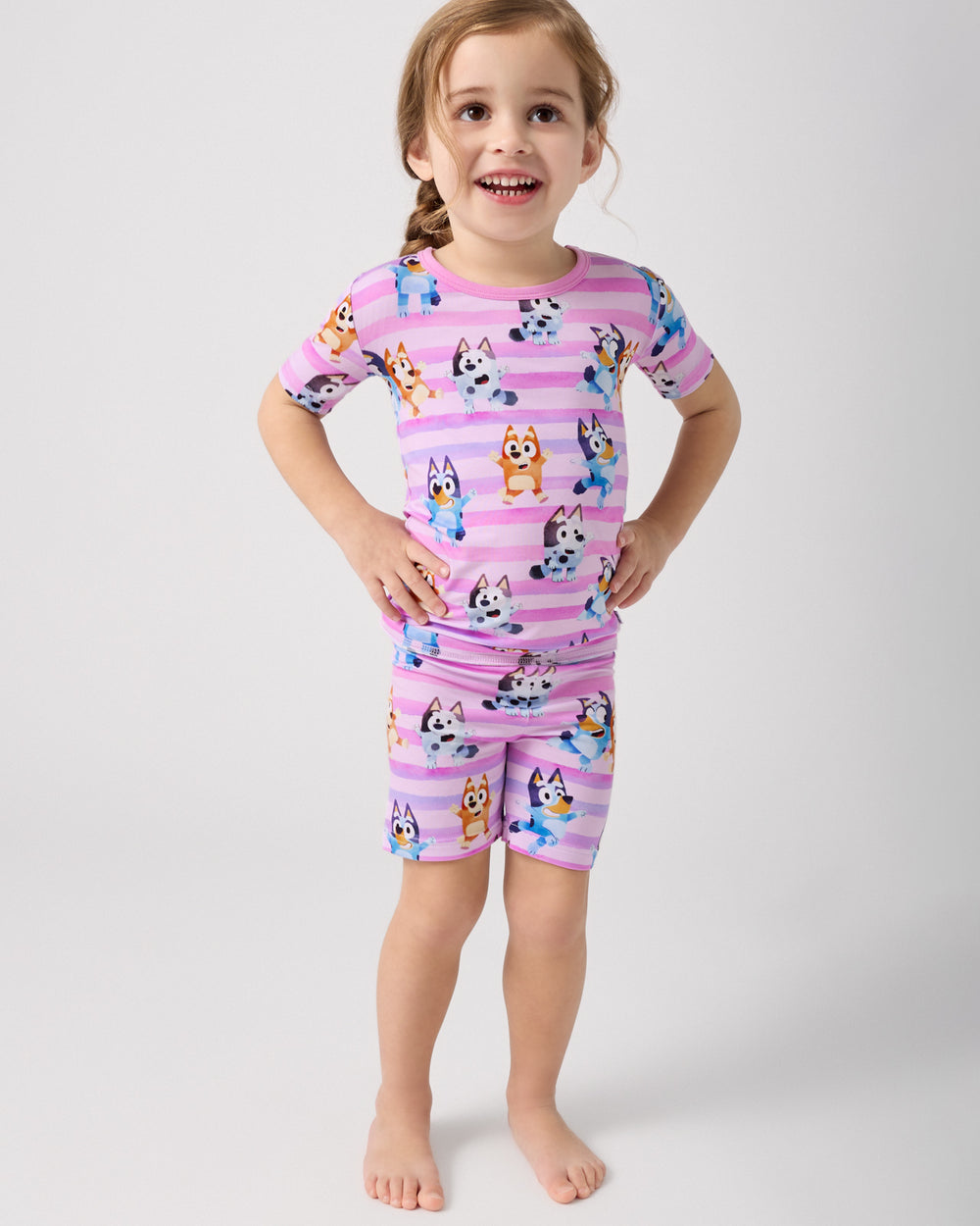 Standing girl wearing the Pink Bluey Dance All Day Two-Piece Short Sleeve & Shorts Pajama Set