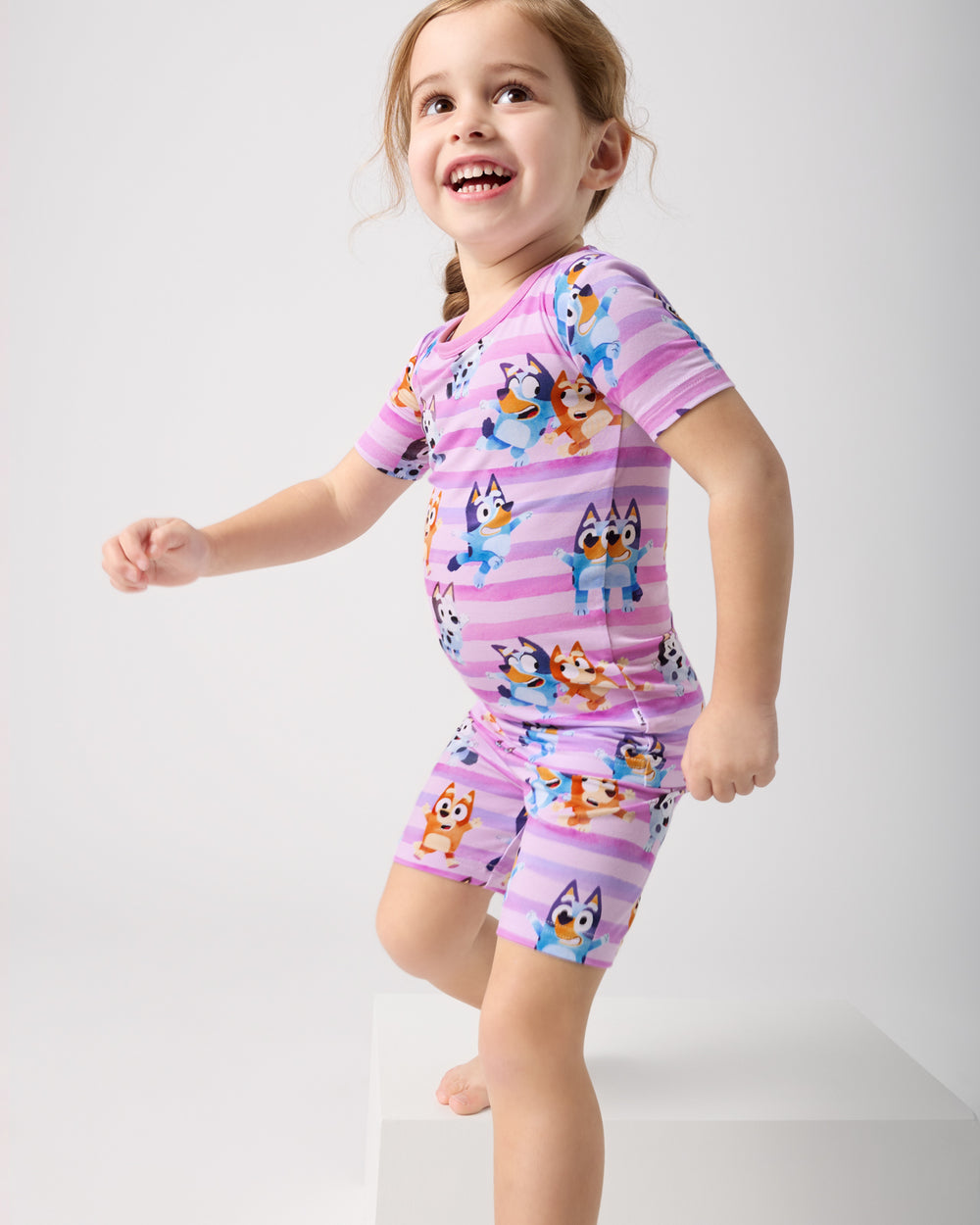 Child in motion wearing the Pink Bluey Dance All Day Two-Piece Short Sleeve & Shorts Pajama Set