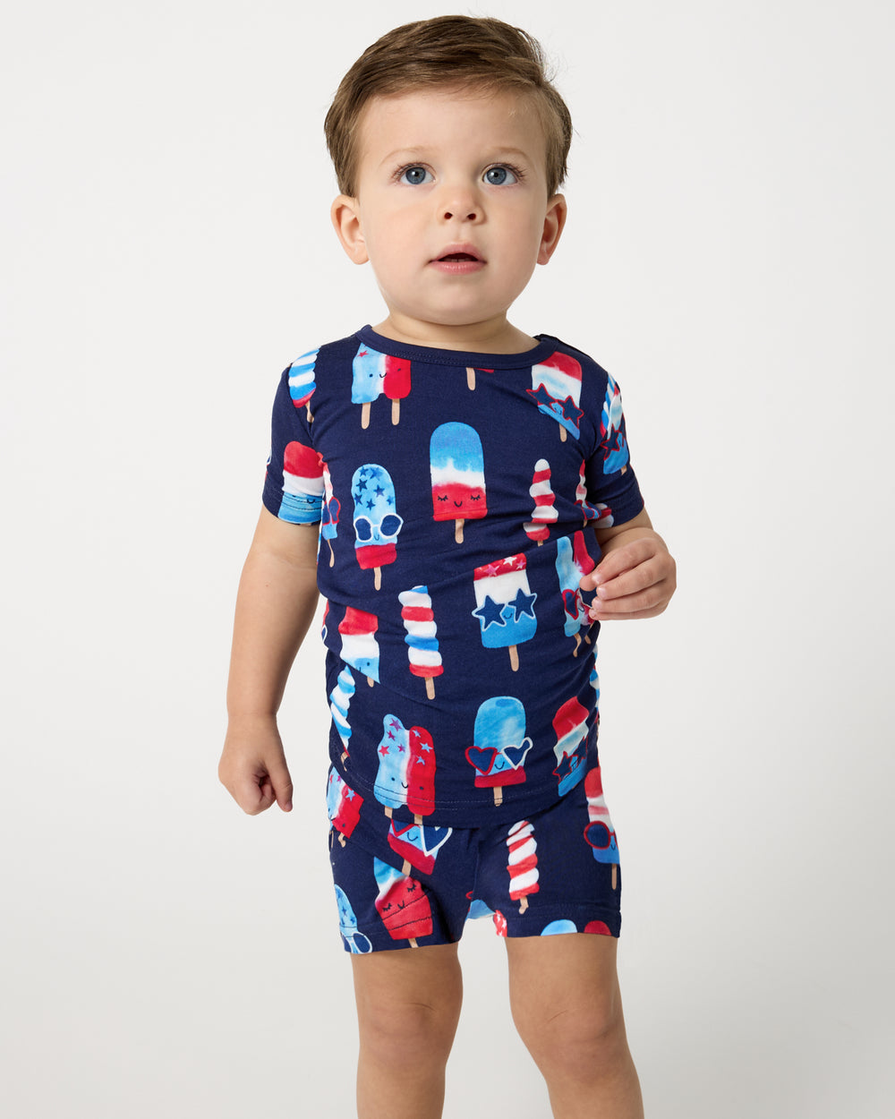 Close up of boy wearing the Sparkle Treats Two-Piece Short Sleeve & Shorts Pajama Set