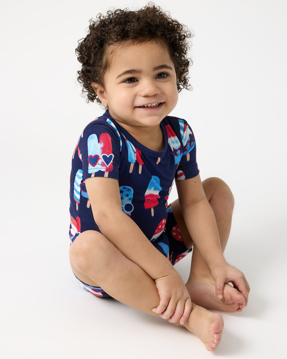 Alternate of sitting boy wearing the Sparkle Treats Two-Piece Short Sleeve & Shorts Pajama Set