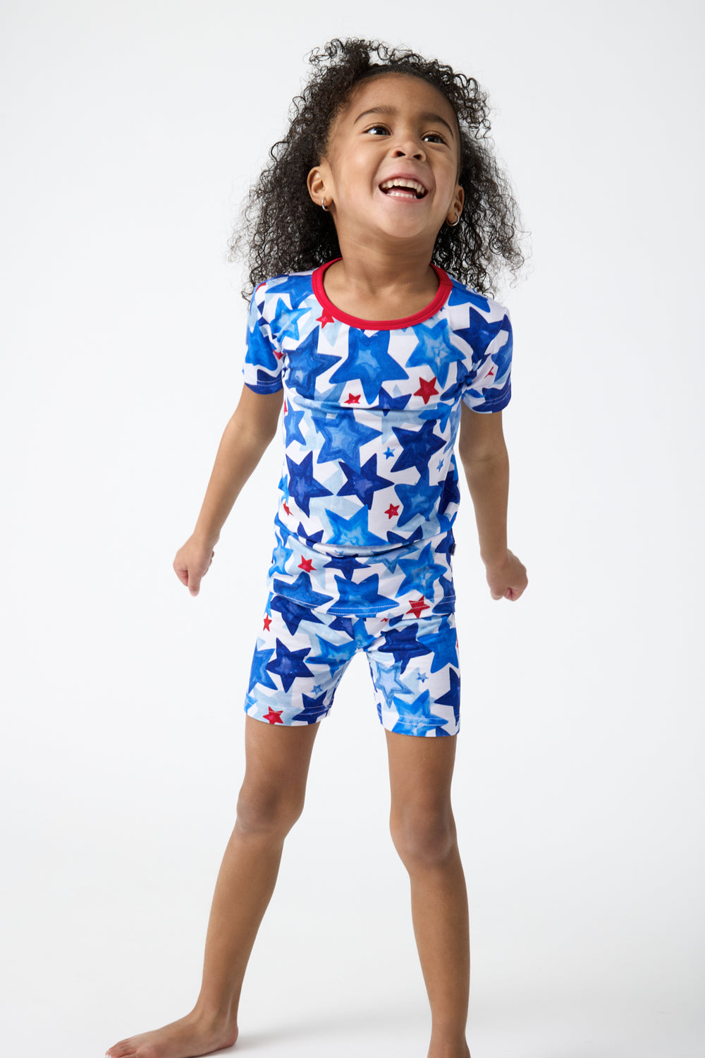 Girl wearing the Starry Splash Two-Piece Short Sleeve & Shorts Pajama Set