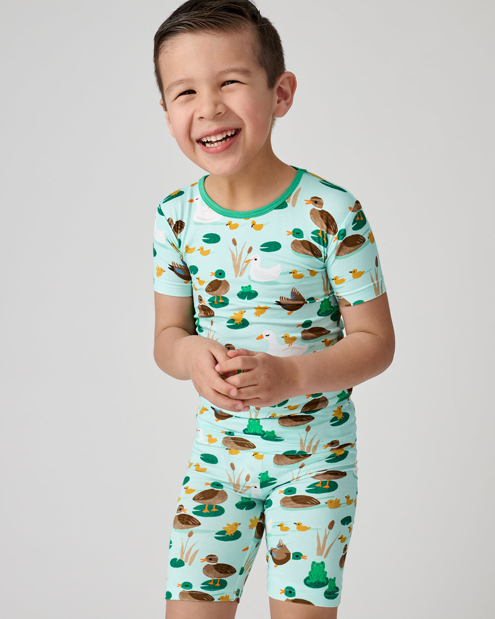 Close up of boy wearing the Puddle Jumpers Two-Piece Short Sleeve & Shorts Pajama Set