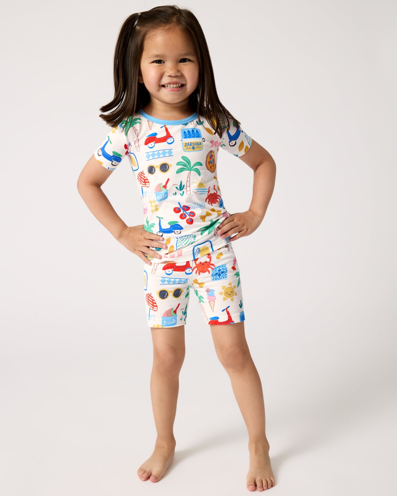 Standing girl wearing the Ciao Bella Two-Piece Short Sleeve & Shorts Pajama Set