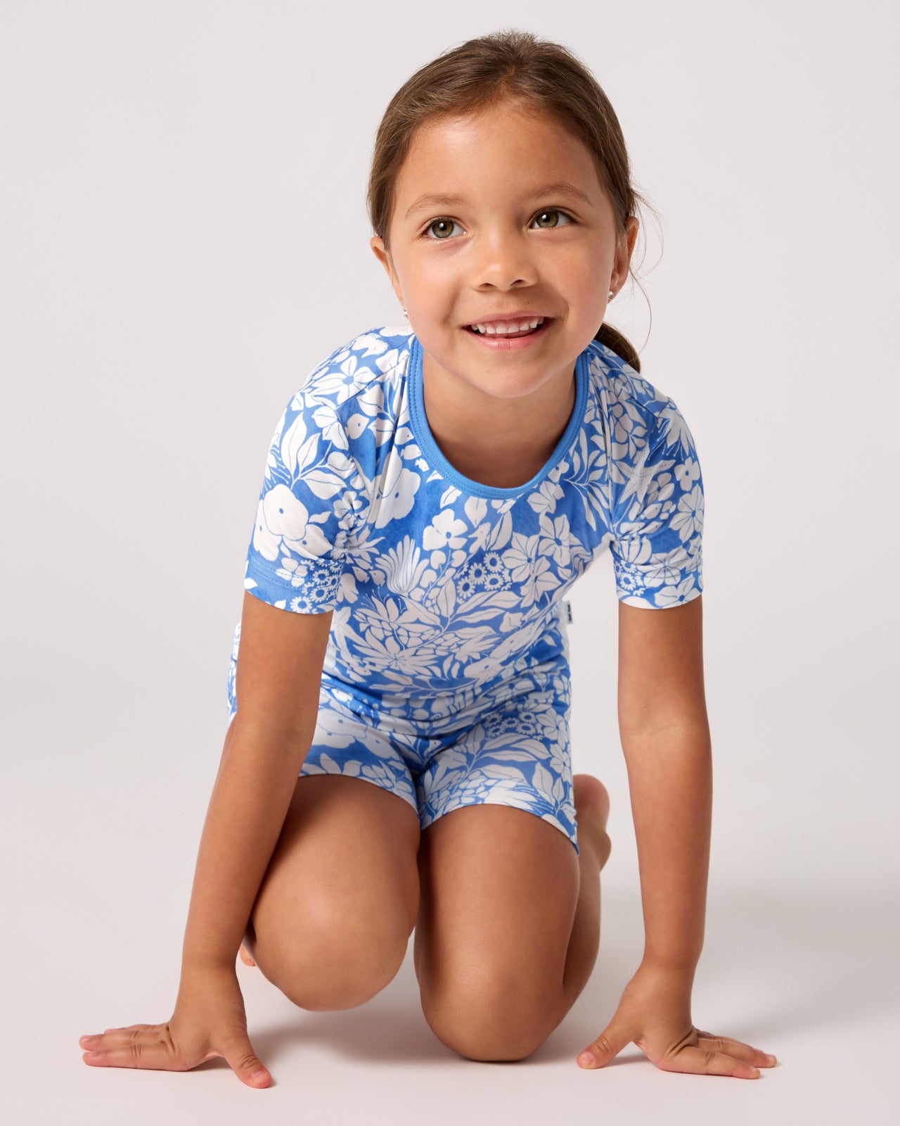 Sitting girl wearing the Azure Garden Two-Piece Short Sleeve & Shorts Pajama Set