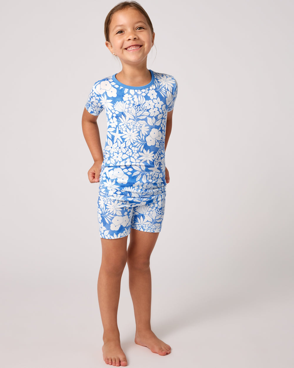 Standing girl wearing the Azure Garden Two-Piece Short Sleeve & Shorts Pajama Set