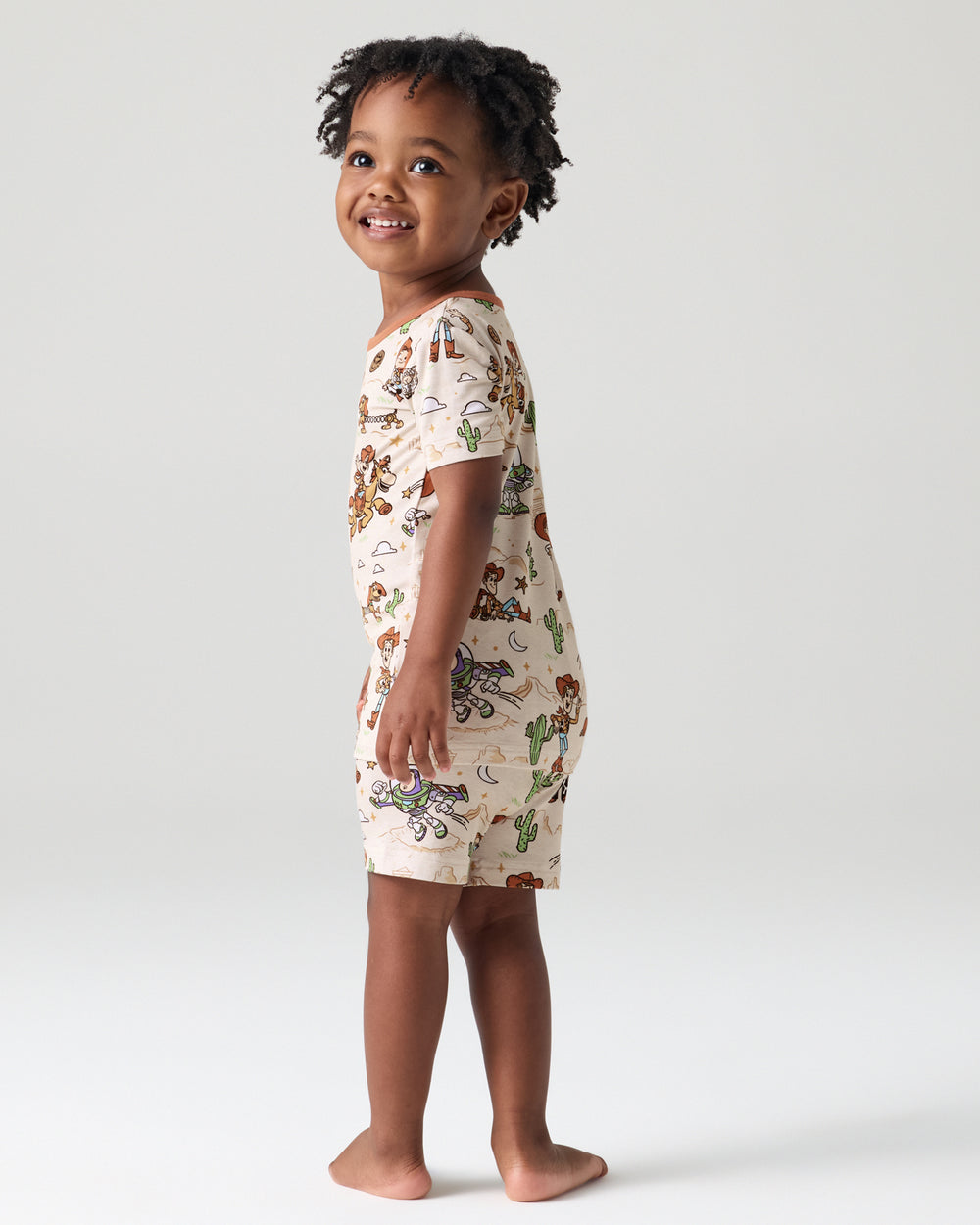Back view of child wearing the Disney & Pixar Woody's Wild West Two-Piece Short Sleeve & Shorts Pajama Set