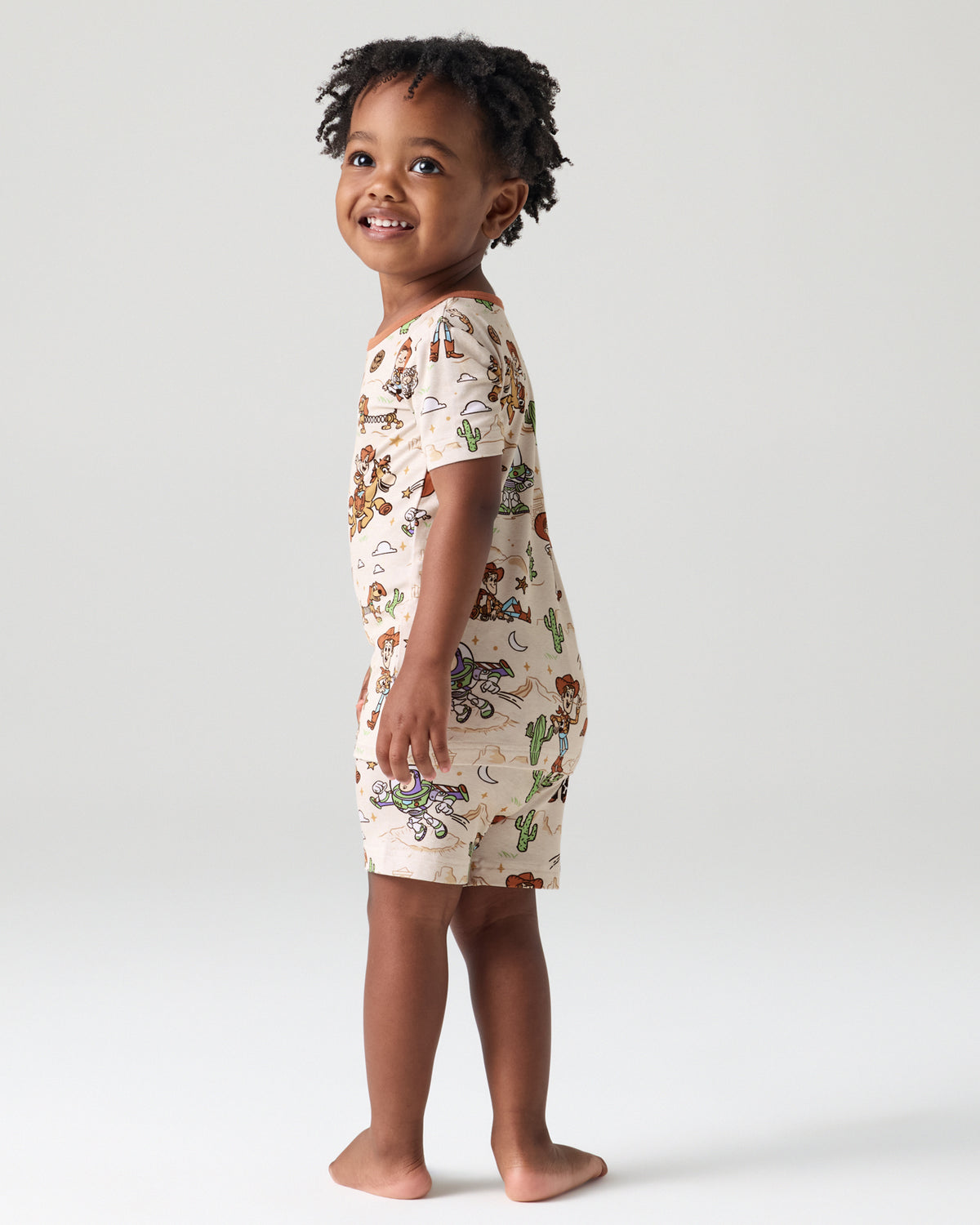 Back view of child wearing the Disney & Pixar Woody's Wild West Two-Piece Short Sleeve & Shorts Pajama Set