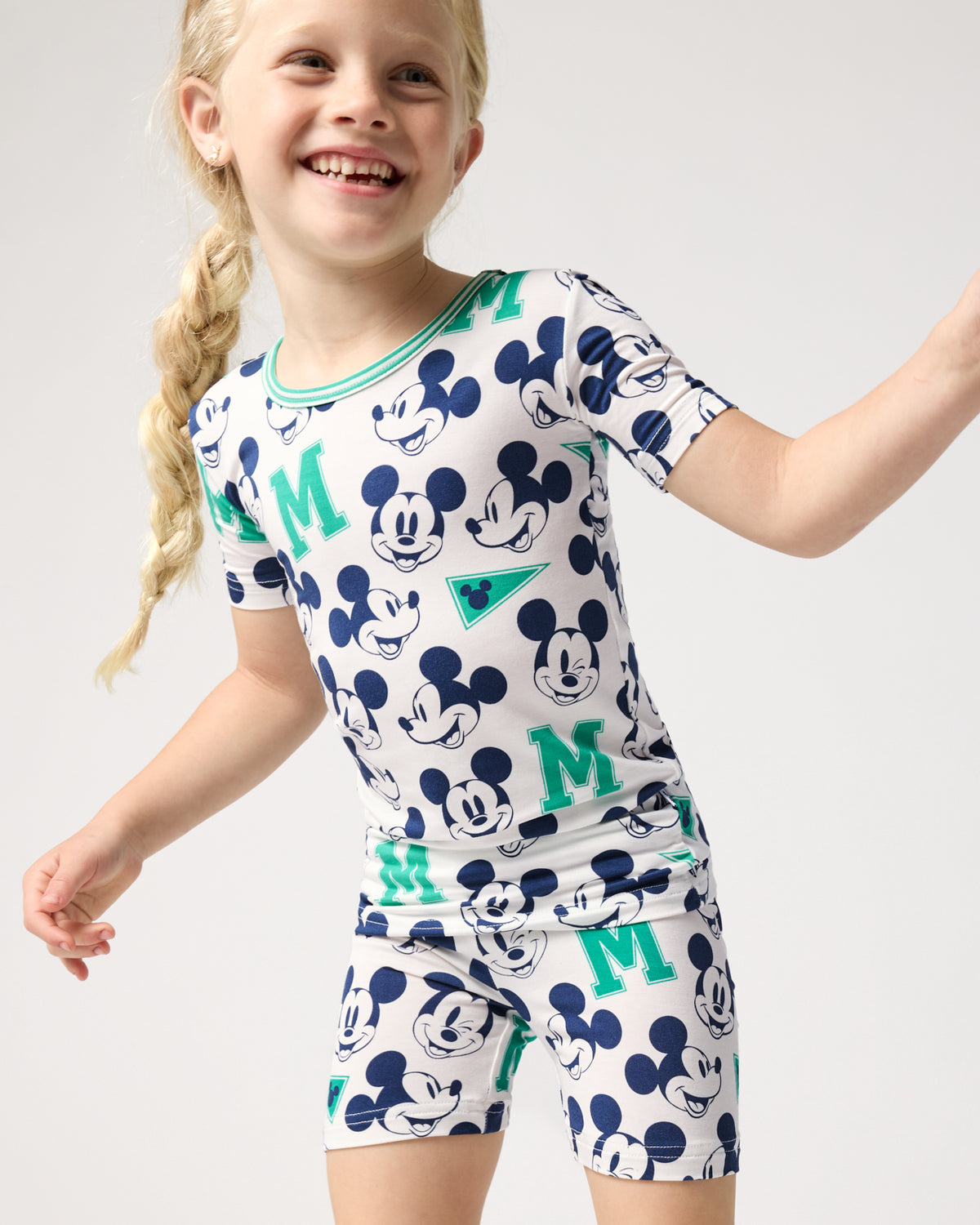 Close up of girl wearing the Disney Varsity Mickey Mouse Two-Piece Short Sleeve & Shorts Pajama Set