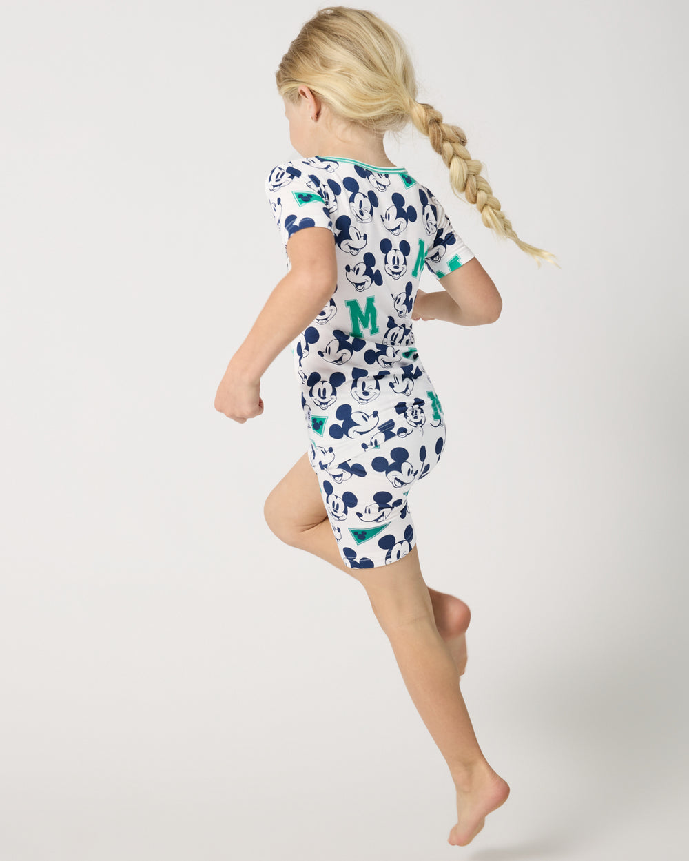 Child in motion wearing the Disney Varsity Mickey Mouse Two-Piece Short Sleeve & Shorts Pajama Set