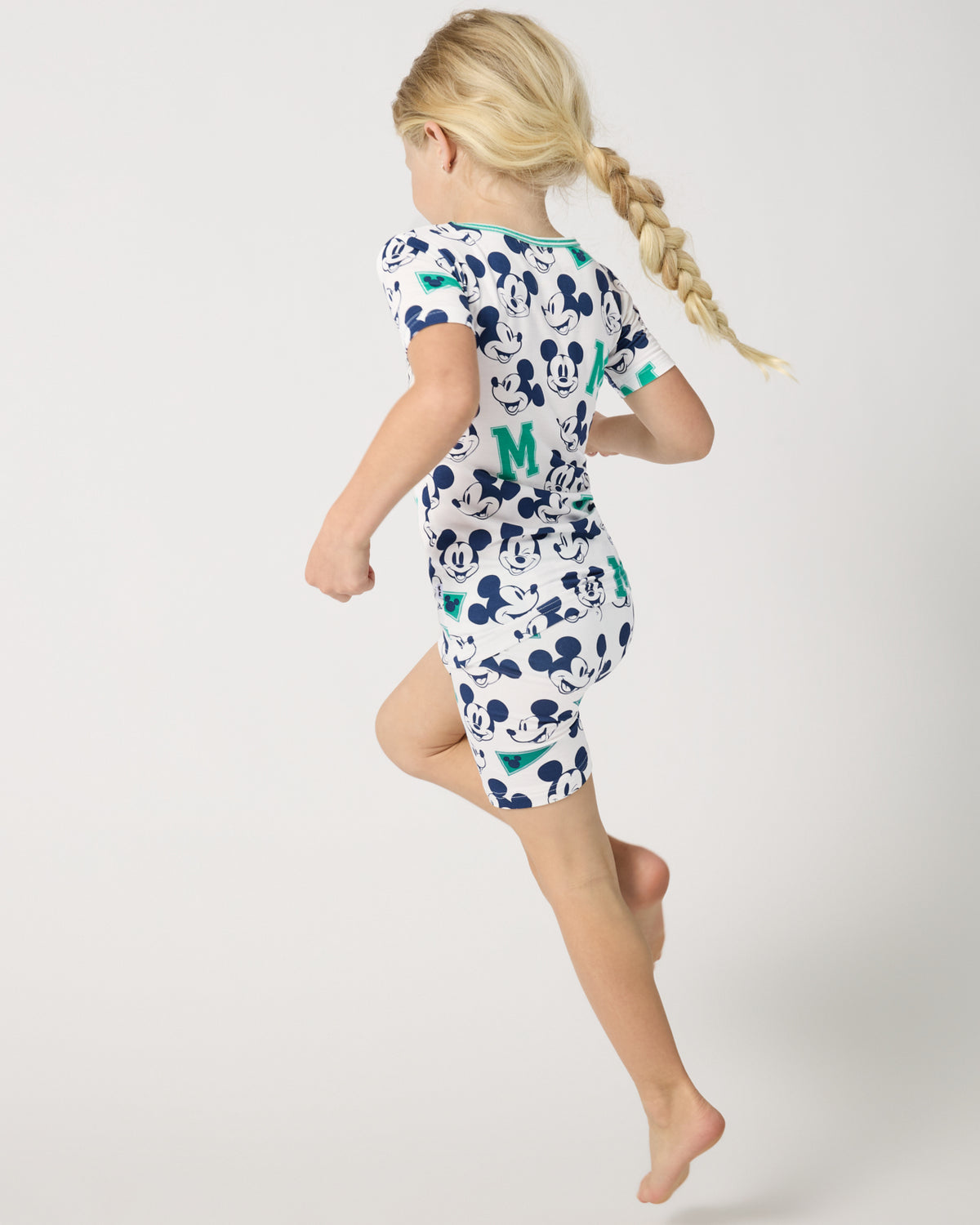 Child in motion wearing the Disney Varsity Mickey Mouse Two-Piece Short Sleeve & Shorts Pajama Set
