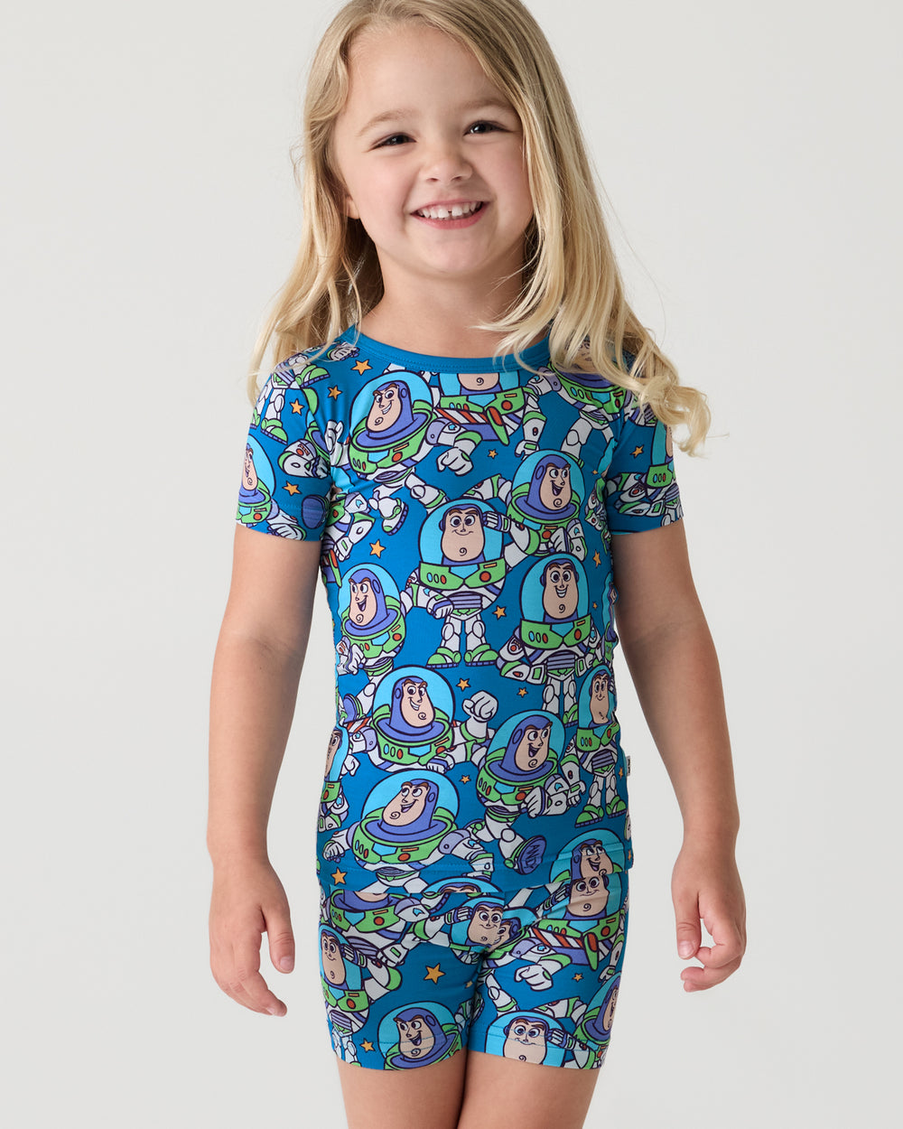 Close up of girl wearing the Disney & Pixar Buzz's Cosmic Crew Two-Piece Short Sleeve & Shorts Pajama Set