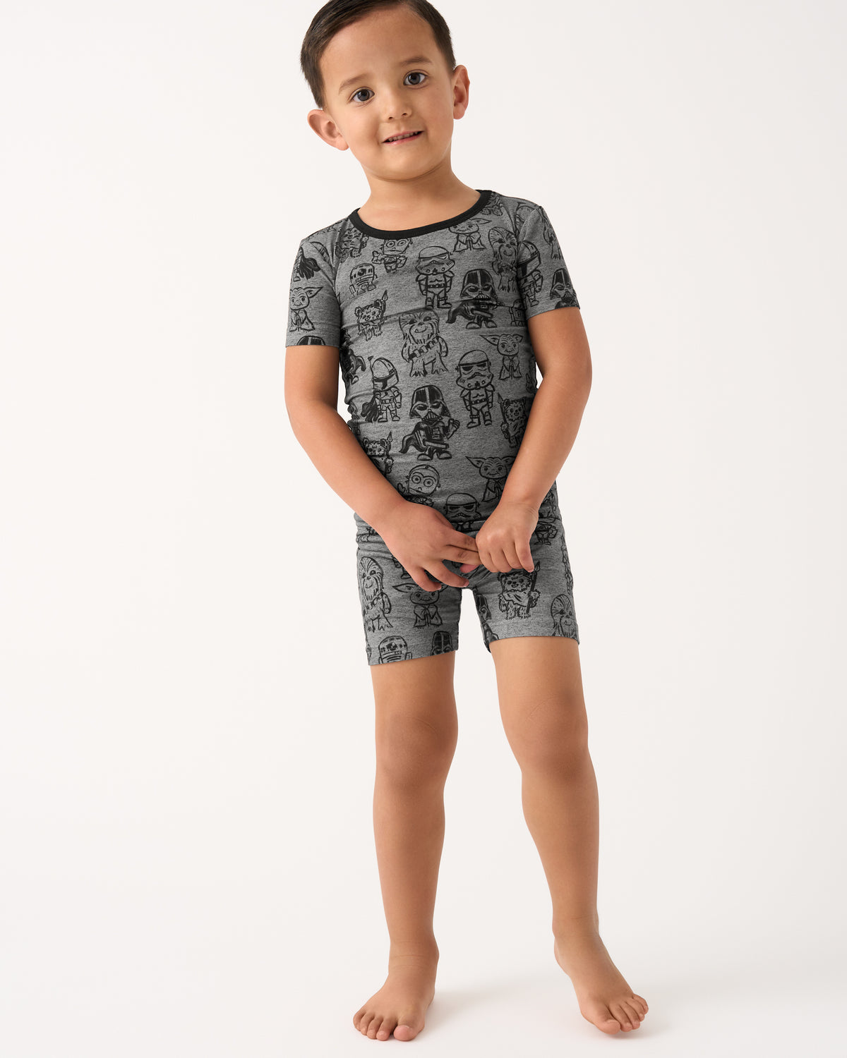 Standing child wearing the Star Wars Far, Far, Away Friends Two-Piece Short Sleeve & Shorts Pajama Set