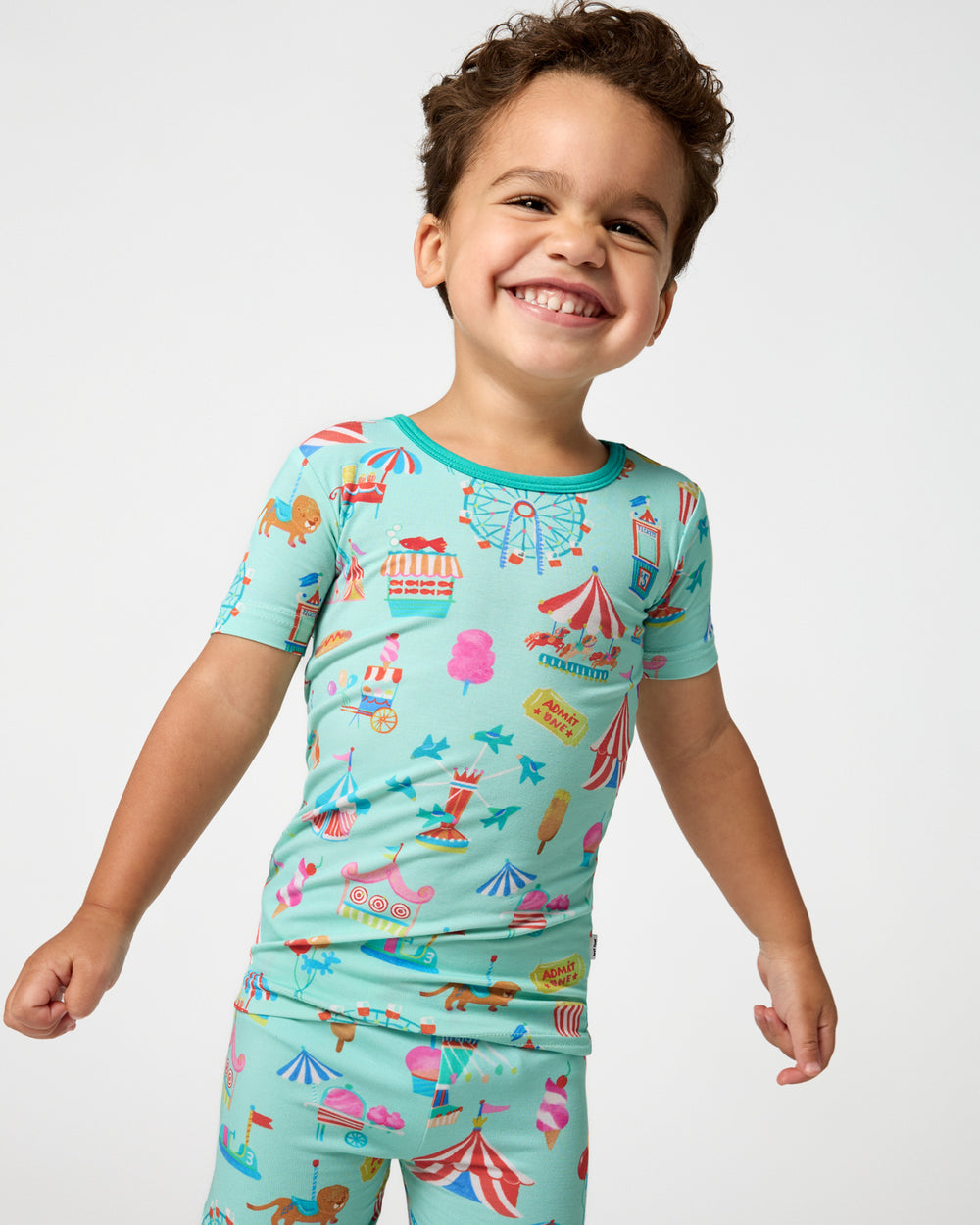 Close up of boy wearing the Fizzy Fair Two-Piece Short Sleeve & Shorts Pajama Set
