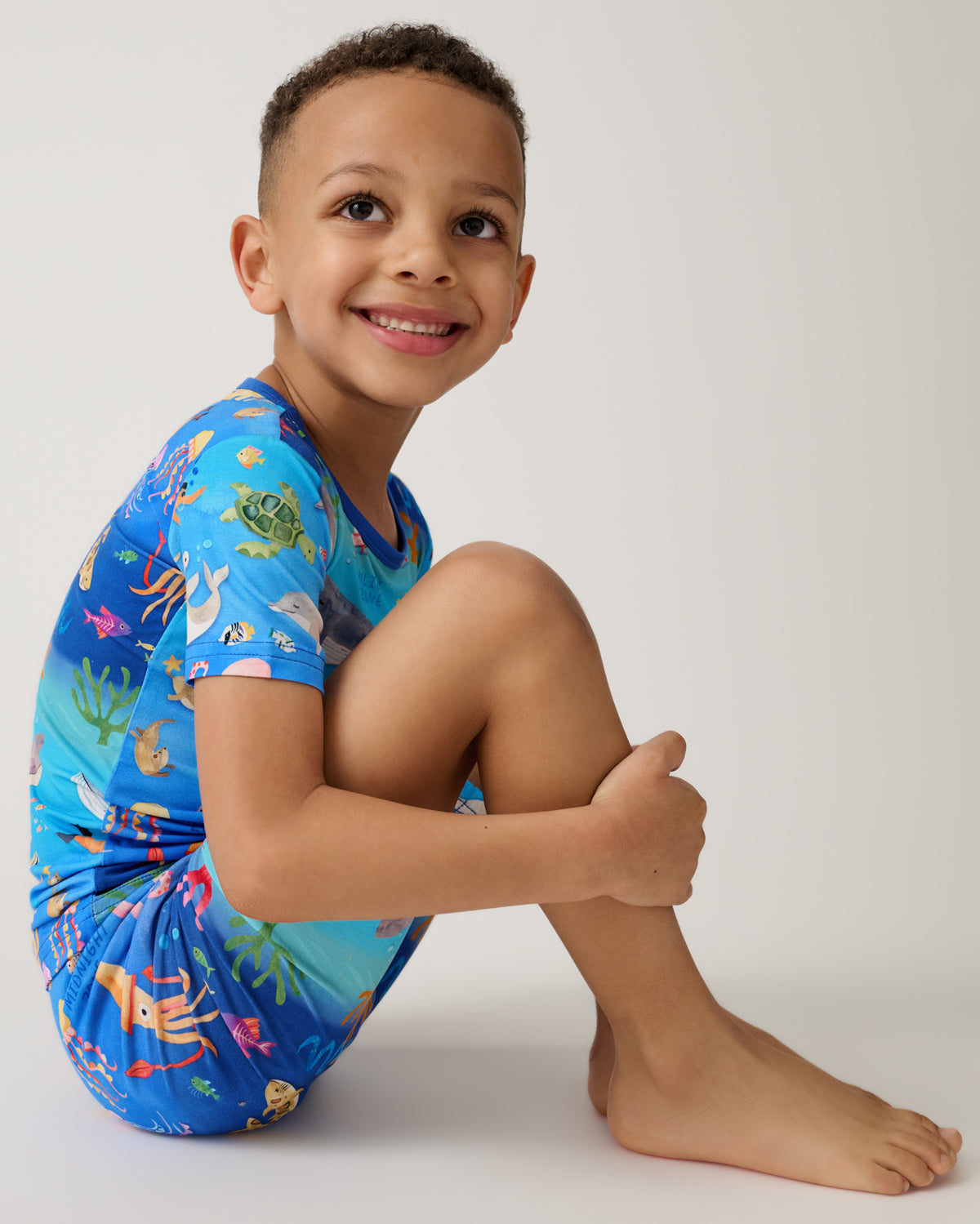 Alternate of sitting boy wearing the Underwater Discovery Two-Piece Short Sleeve & Shorts Pajama Set