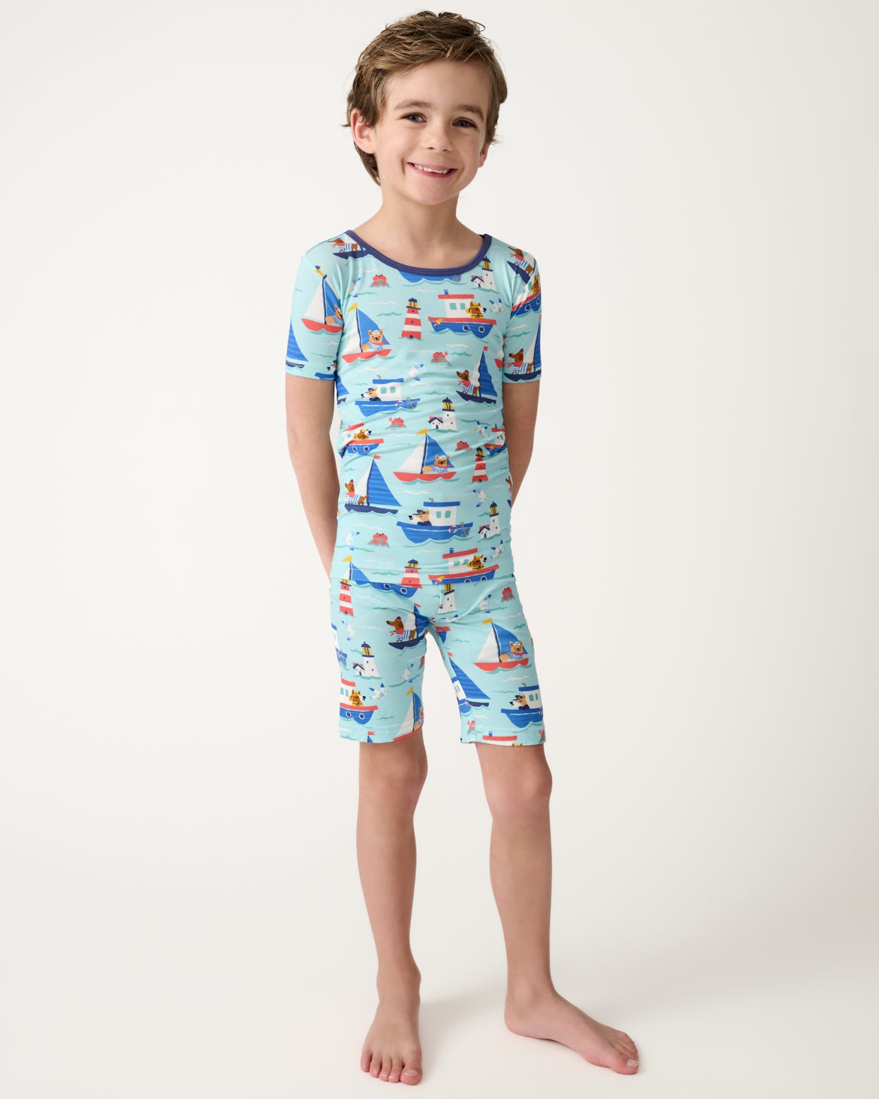 Standing boy wearing the Nautical Paws Two-Piece Short Sleeve & Shorts Pajama Set