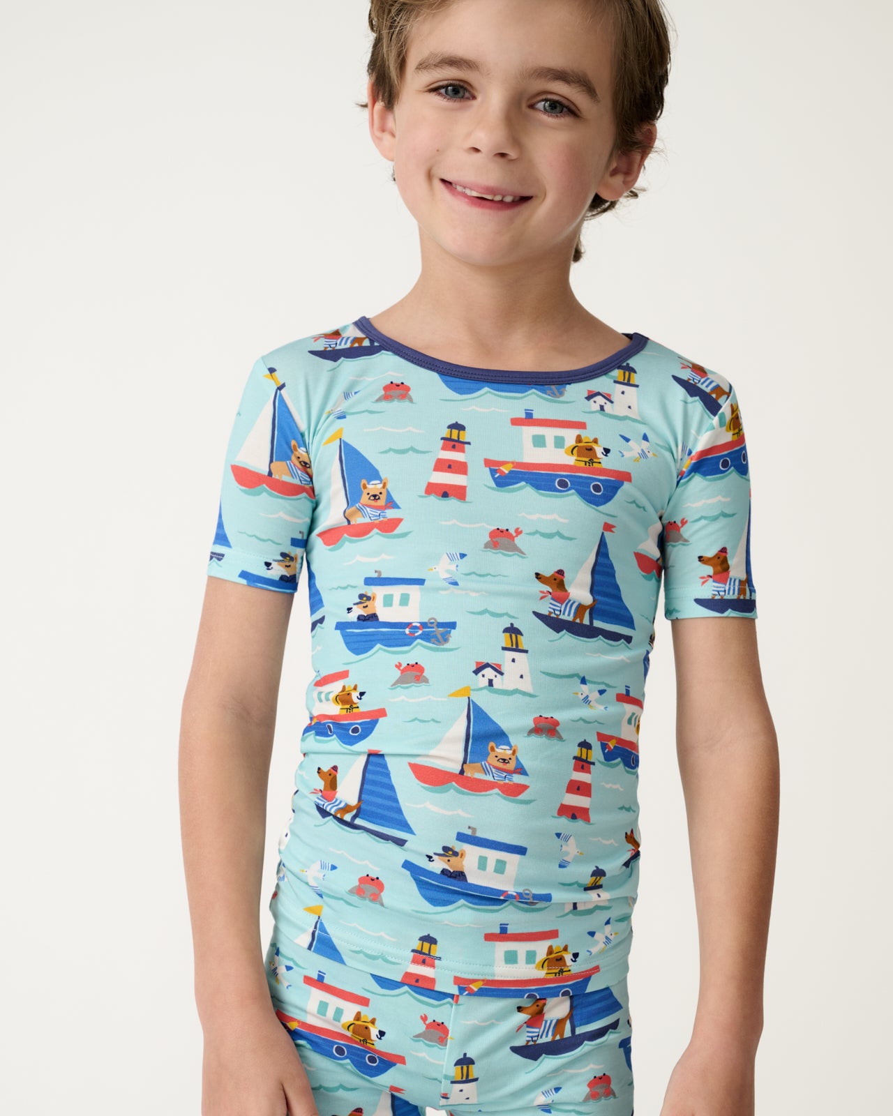 Close up of boy wearing the Nautical Paws Two-Piece Short Sleeve & Shorts Pajama Set