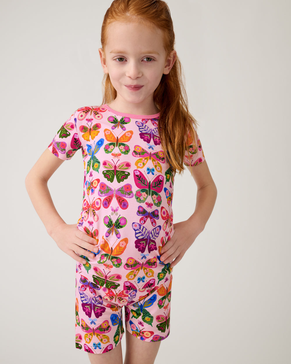 Girl wearing the Flutter Garden Two-Piece Short Sleeve & Shorts Pajama Set