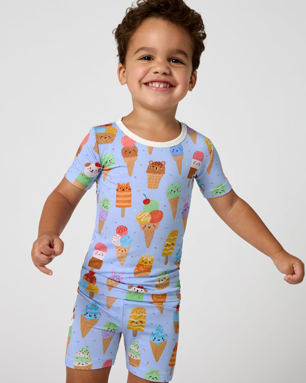 Close up of boy wearing the Scoop Squad Two-Piece Short Sleeve & Shorts Pajama Set