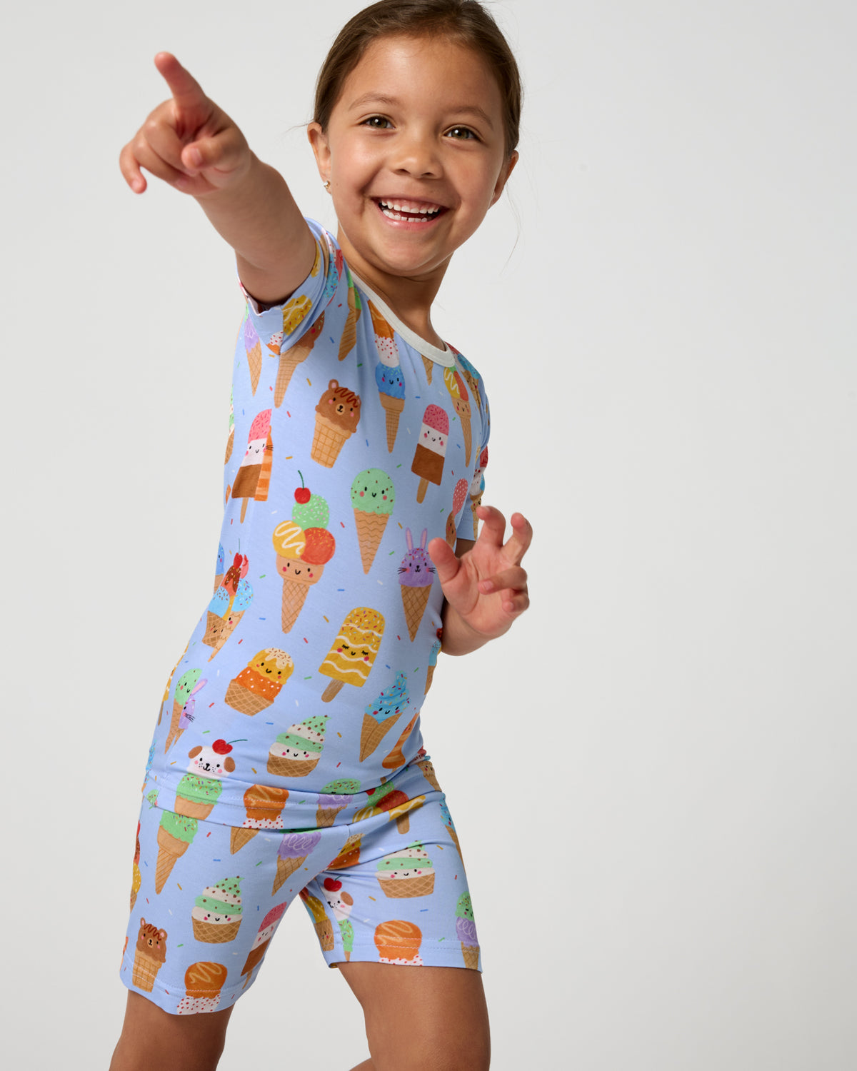 Girl wearing the Scoop Squad Two-Piece Short Sleeve & Shorts Pajama Set