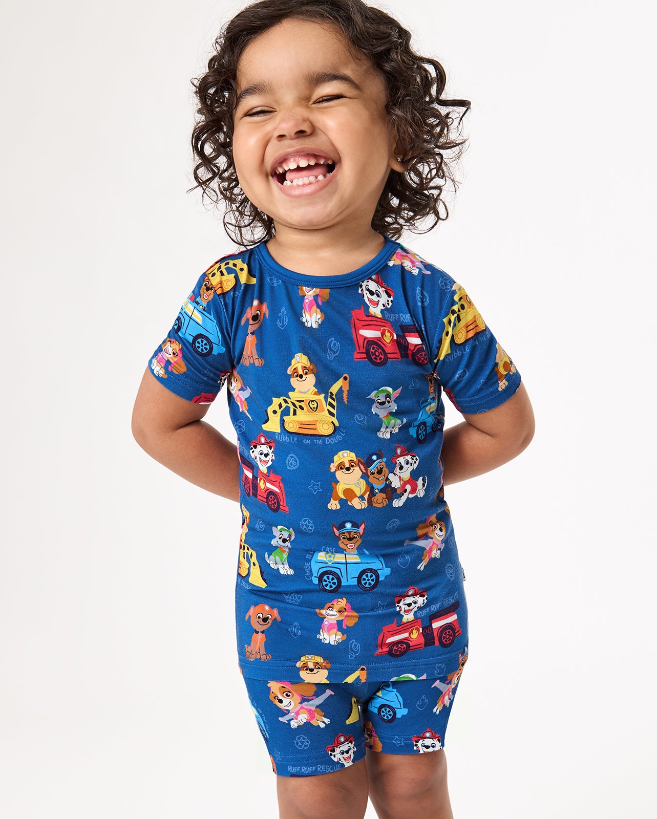 Child wearing the PAW Patrol Adventure Bay Heroes Two-Piece Short Sleeve & Shorts Pajama Set