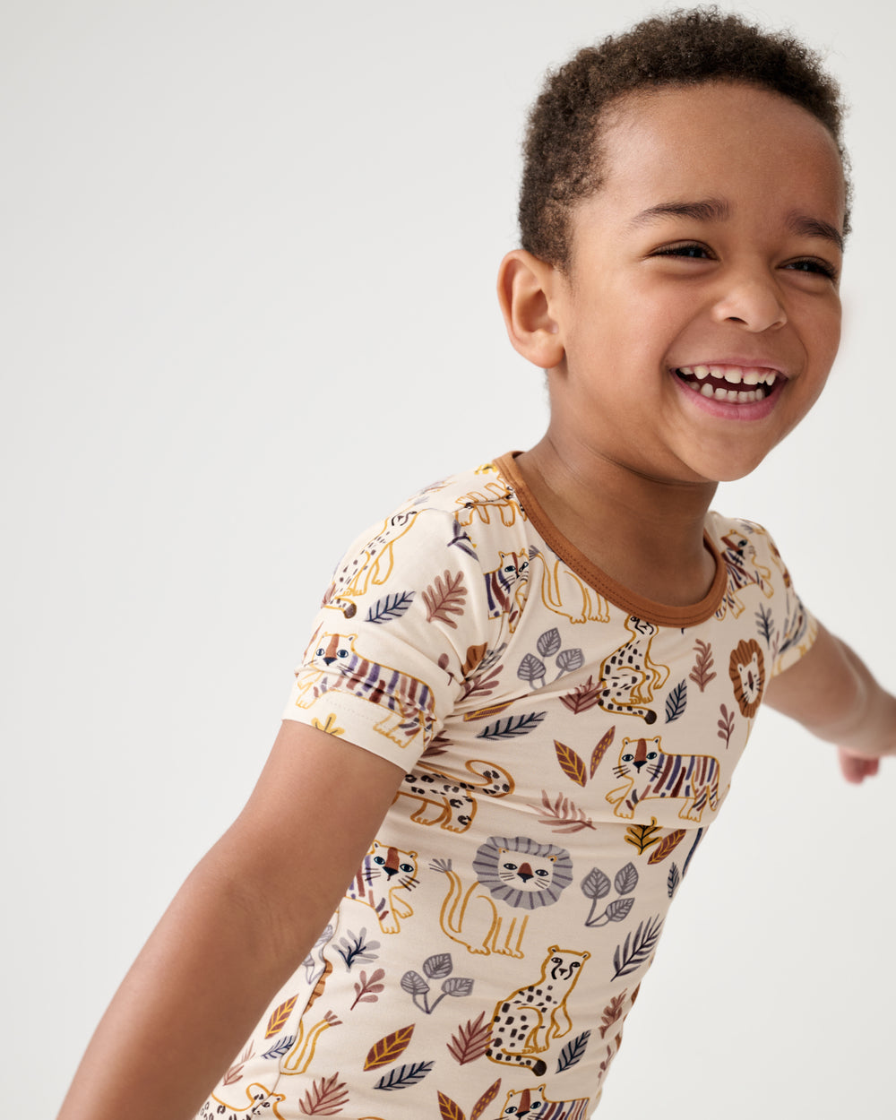 Close up of boy wearing the Savanna Friends Two-Piece Short Sleeve & Shorts Pajama Set