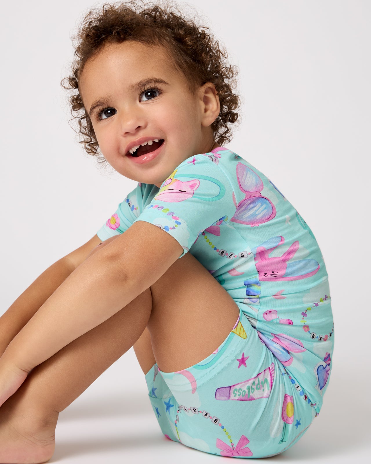 Sitting child wearing the Slumber Club Two-Piece Short Sleeve & Shorts Pajama Set