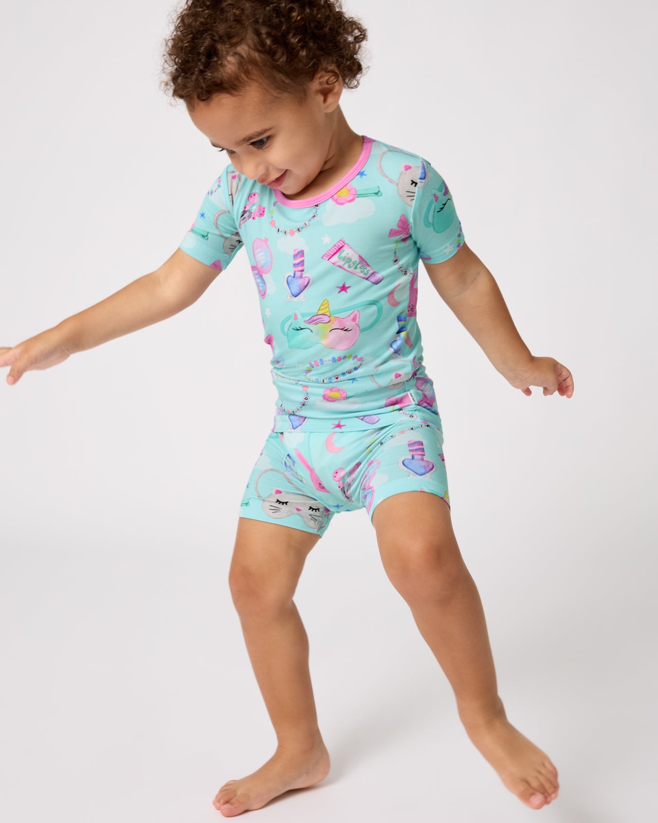 Child wearing the Slumber Club Two-Piece Short Sleeve & Shorts Pajama Set