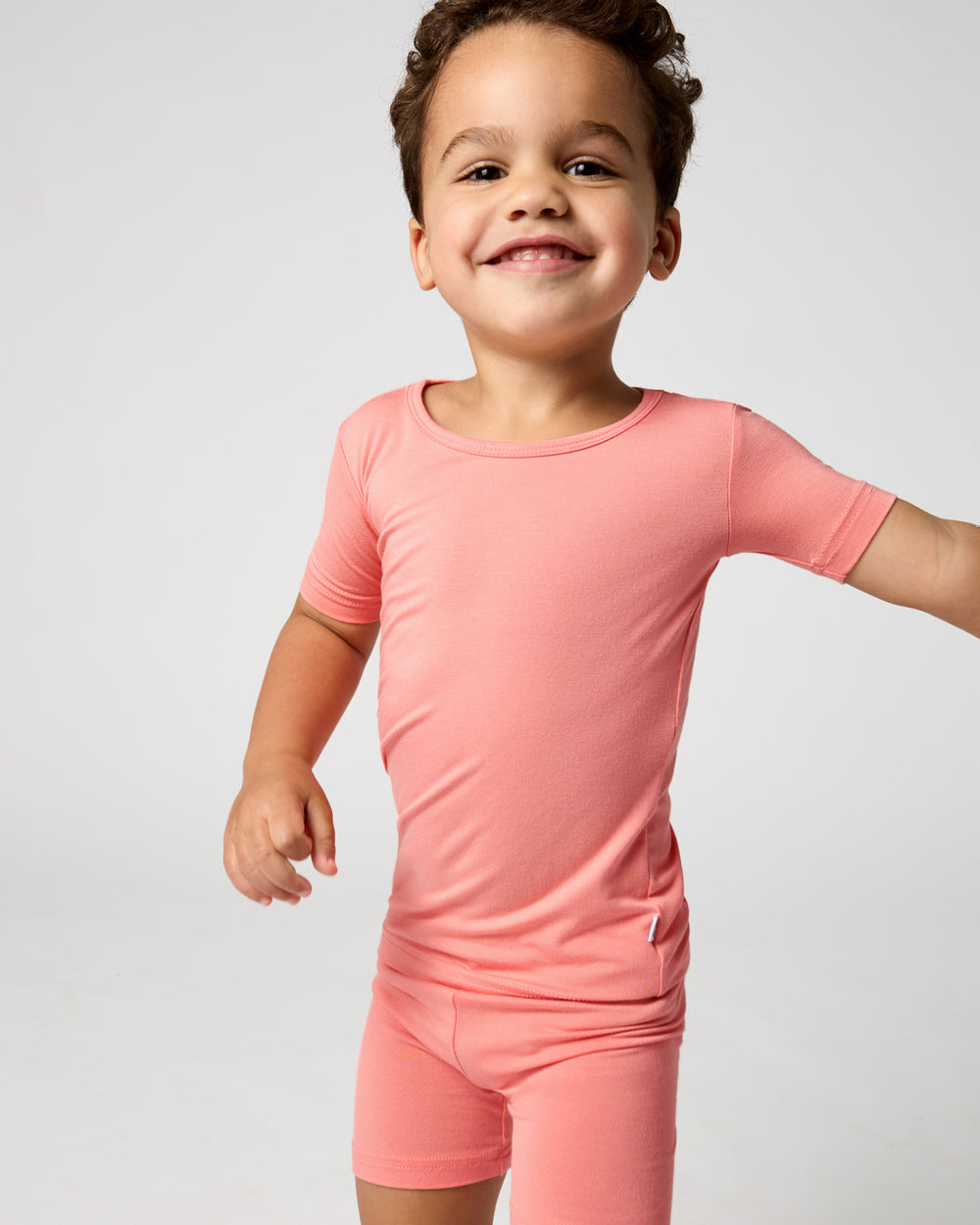 Close up of boy wearing the Sweet Papaya Two-Piece Short Sleeve & Shorts Pajama Set