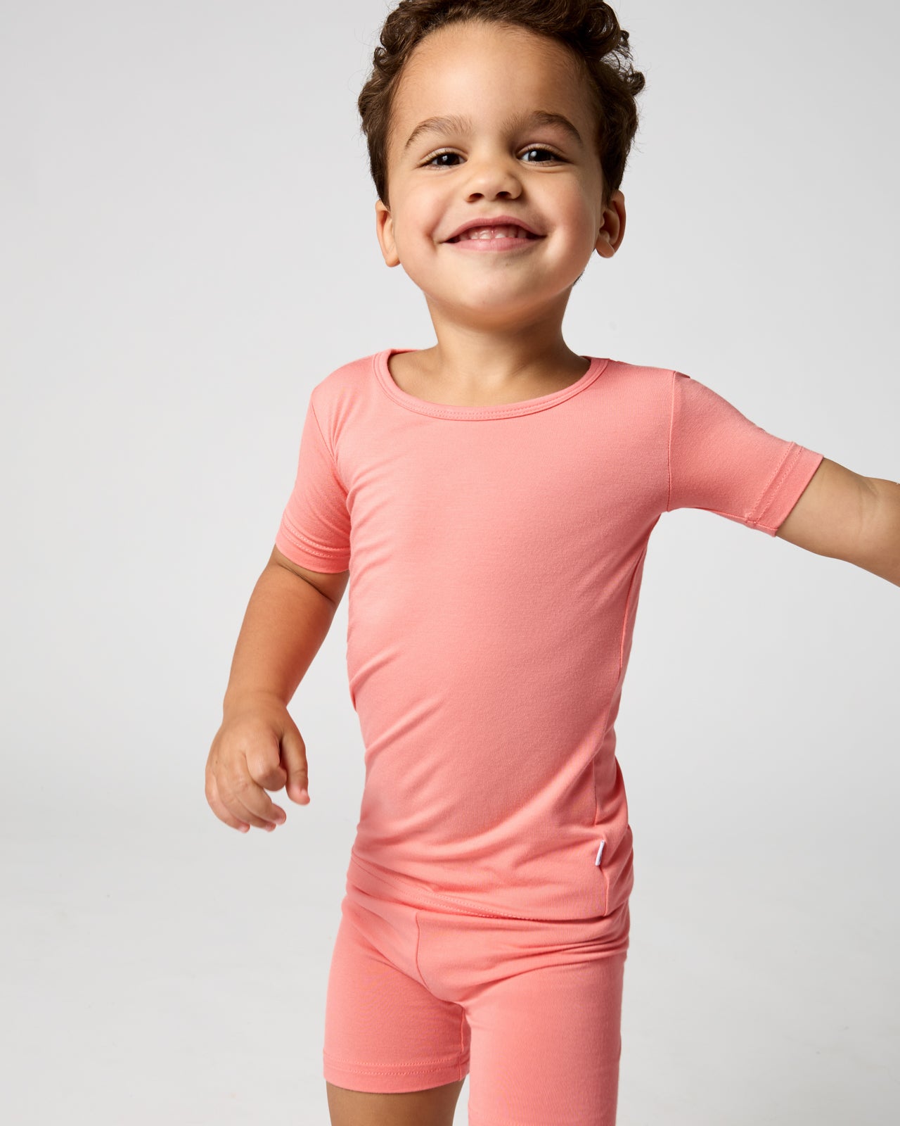 Close up of boy wearing the Sweet Papaya Two-Piece Short Sleeve & Shorts Pajama Set